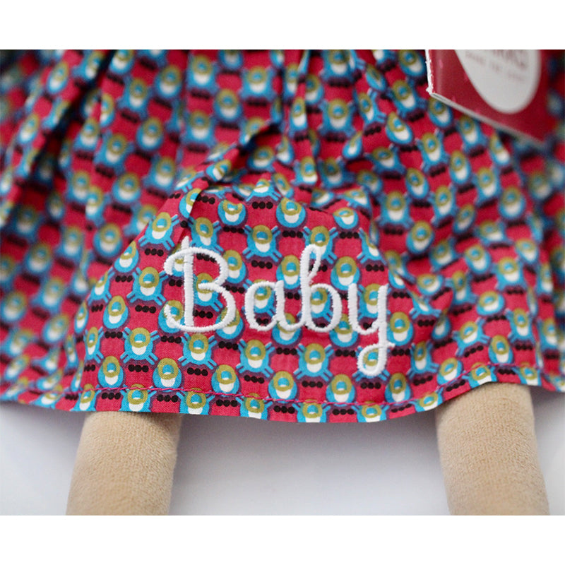 A personalised Bonikka Clara Rag Doll with beautiful dotted embroidered dress and dark hair