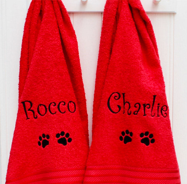 Two red pet towels embroidered or personalised with the names Rocco and Charlie