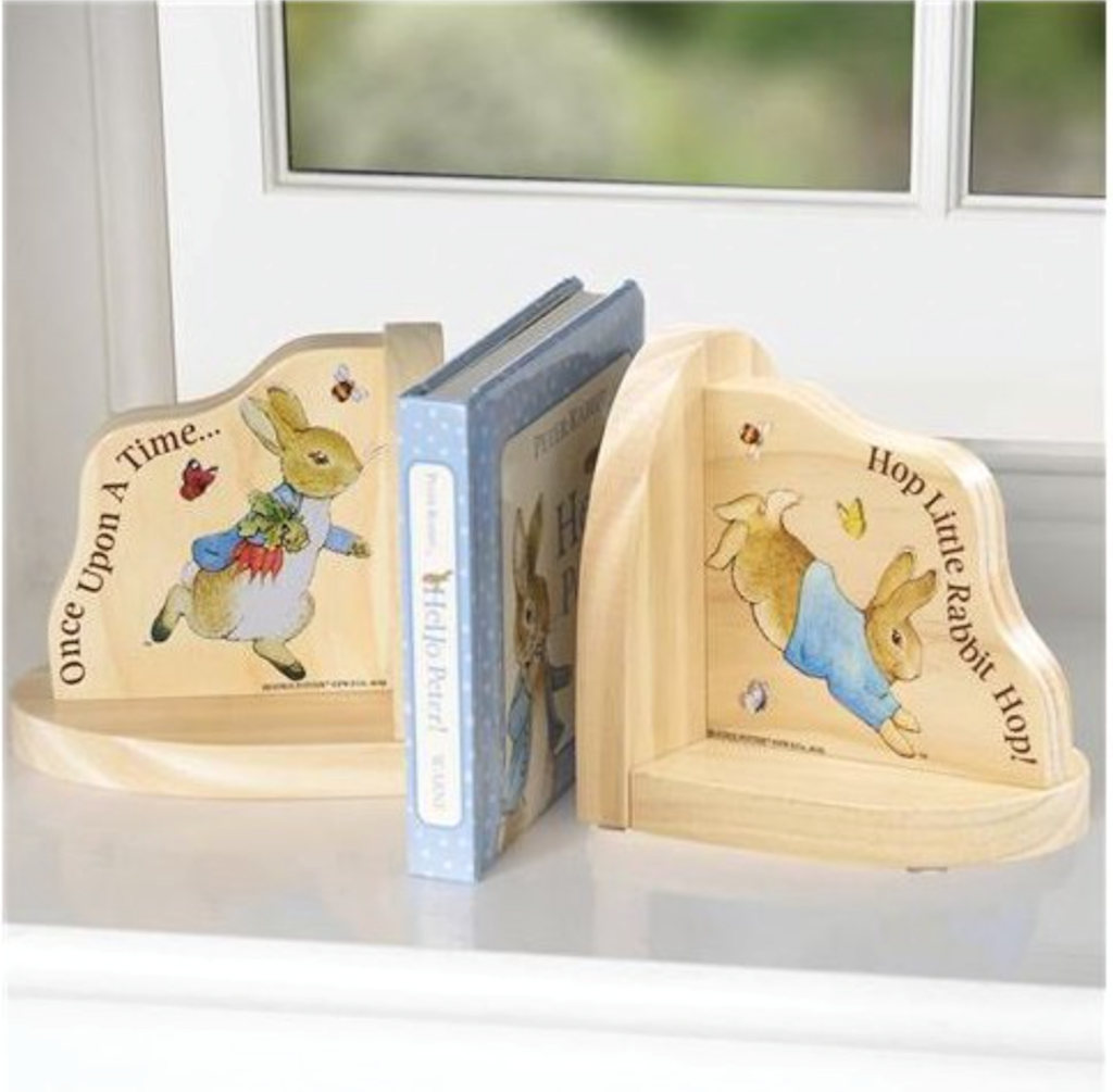 Beautiful Peter Rabbit Wooden Bookends displayed on window sill with book