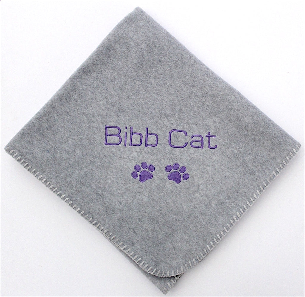 A folded Pet Grey Blanket Personalised for Cat or Dog with name and paw prints