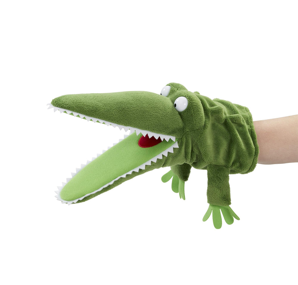 The enormous green crocodile hand puppet with bulging eyes and mouth wide open and ready to bite