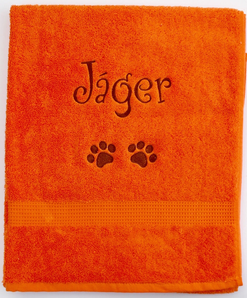 A large orange personalised Dog Towel with name and dog paws