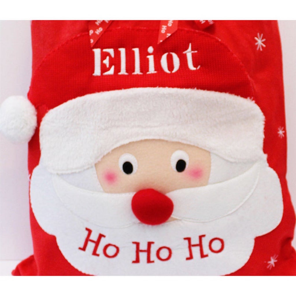 Close up of a large red personalised Santa Sack with large red nose, Ho Ho Ho across Santa's Face and embroidered name across the hat