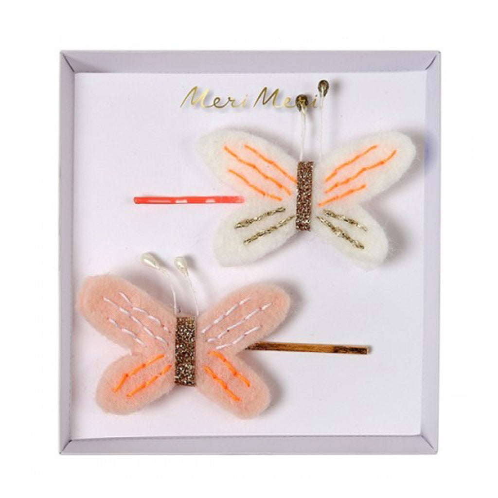 Two Meri Meri butterfly hair pins crafted in felt embellished with glitter stitching and pearl antenna