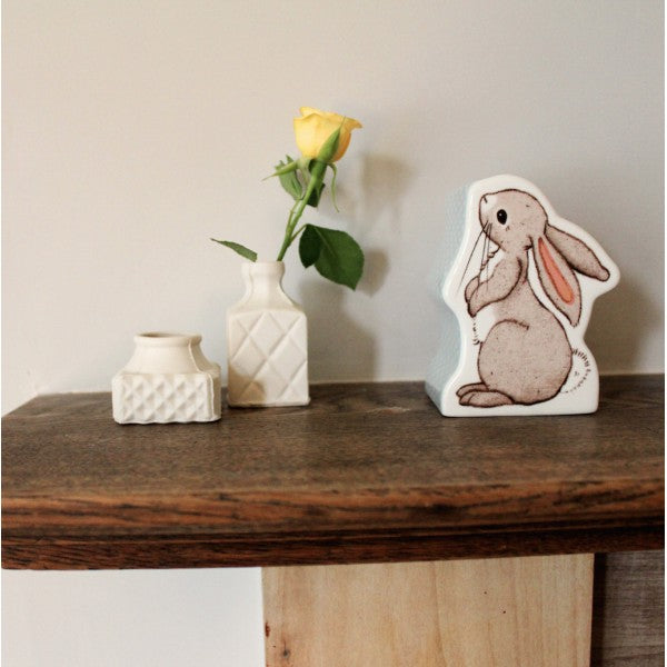 On a shelf a 100% fine china money box in the shape of a favourite bunny, Boo.