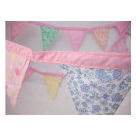 Close up of a pretty soft fabric bunting in pink.