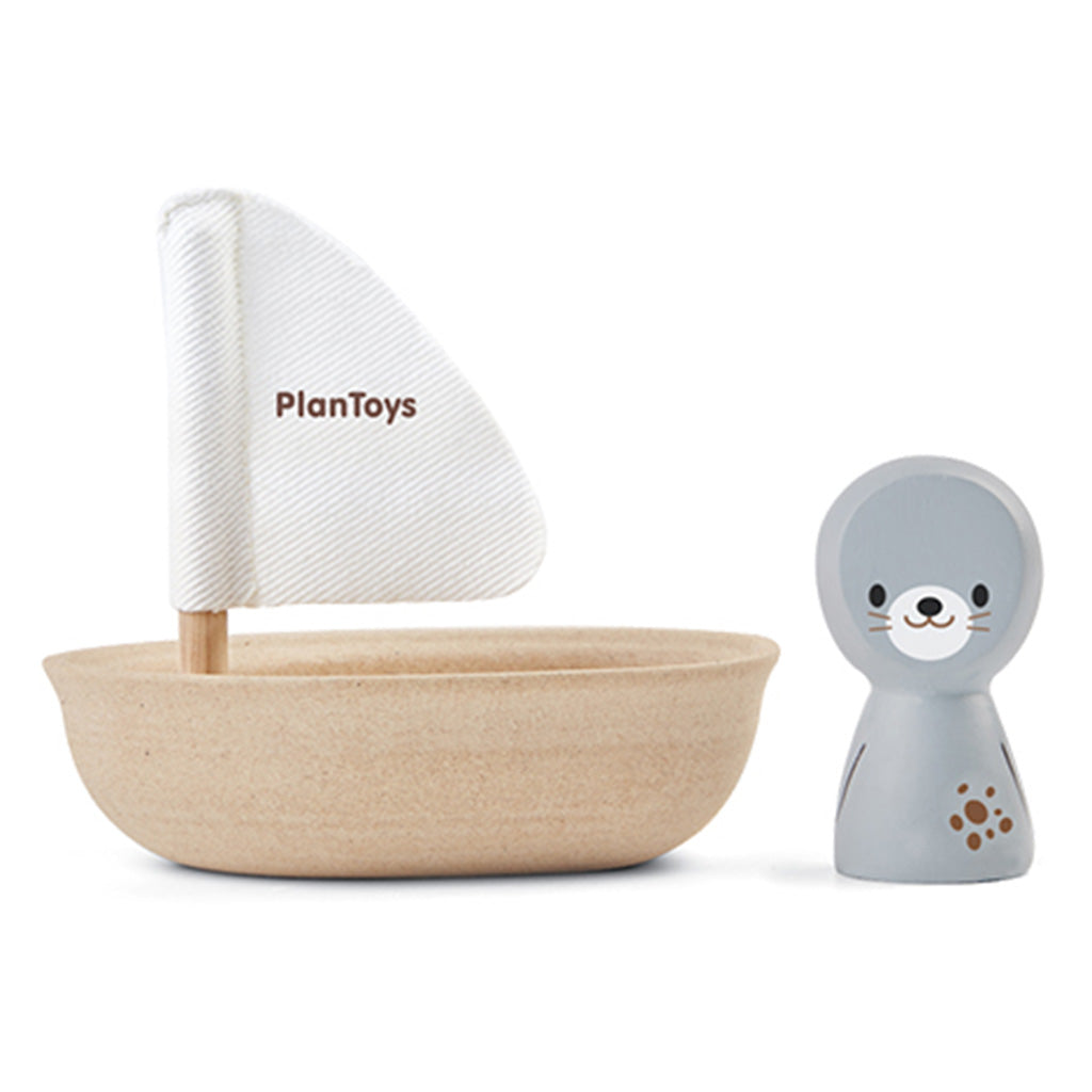 Bath time fun with wooden toy sailboat with a little seal sailor by Plan Toys